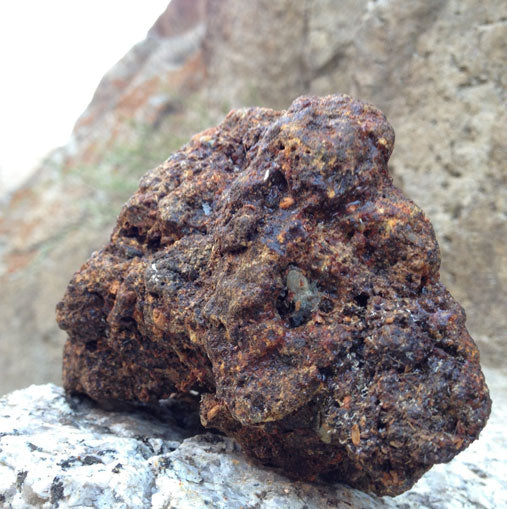 Raw Shilajit embedded in rock